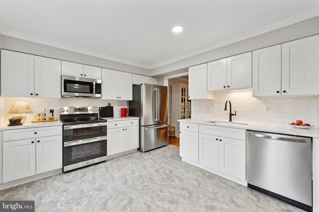 121 Harrison St NE, Leesburg, VA 20176 - kitchen featuring stainless steel appliances, crown molding, light countertops, white cabinets, and decorative backsplash
