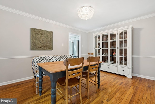 121 Harrison St NE, Leesburg, VA 20176 - dining area with a chandelier, hardwood / wood-style floors, and crown molding