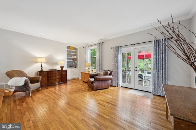 121 Harrison St NE, Leesburg, VA 20176 - living area with ornamental molding, light wood-type flooring, built in shelves, and french doors