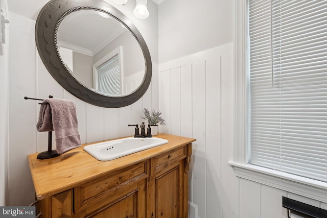 121 Harrison St NE, Leesburg, VA 20176 - bathroom featuring a decorative wall, ornamental molding, vanity, and a wainscoted wall