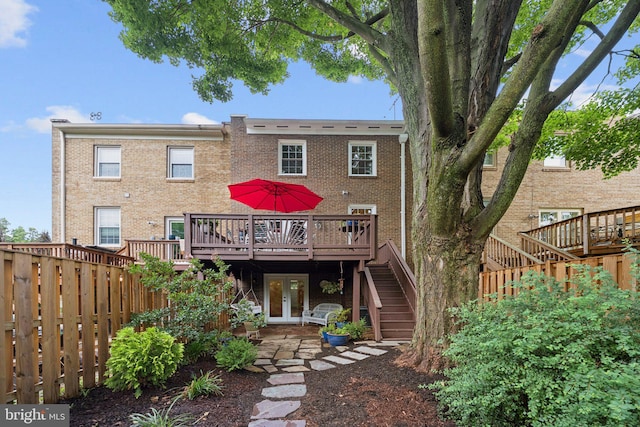 121 Harrison St NE, Leesburg, VA 20176 - back of property featuring stairway, a deck, brick siding, and french doors