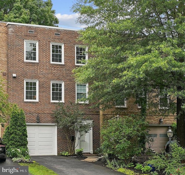 121 Harrison St NE, Leesburg, VA 20176 - view of front of property featuring an attached garage, brick siding, and driveway