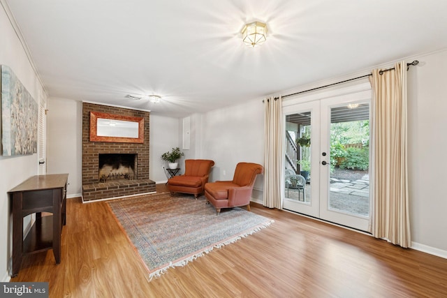 121 Harrison St NE, Leesburg, VA 20176 - sitting room with french doors, wood finished floors, and a brick fireplace