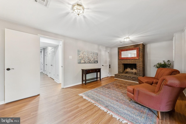 121 Harrison St NE, Leesburg, VA 20176 - living area with light wood-style flooring and a fireplace