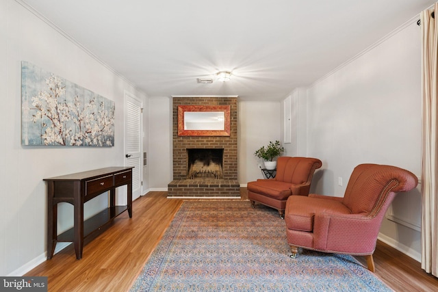 121 Harrison St NE, Leesburg, VA 20176 - living area featuring light wood-type flooring, crown molding, and a brick fireplace
