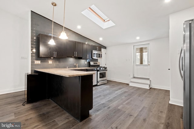 1805 Chestnut St, Philadelphia, PA 19103 - kitchen with appliances with stainless steel finishes, dark wood-style flooring, light countertops, decorative backsplash, and lofted ceiling