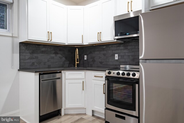 1805 Chestnut St, Philadelphia, PA 19103 - kitchen with stainless steel appliances, dark countertops, and white cabinetry