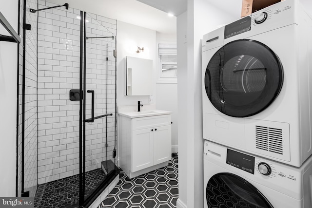1805 Chestnut St, Philadelphia, PA 19103 - washroom featuring stacked washer / drying machine and dark tile patterned floors