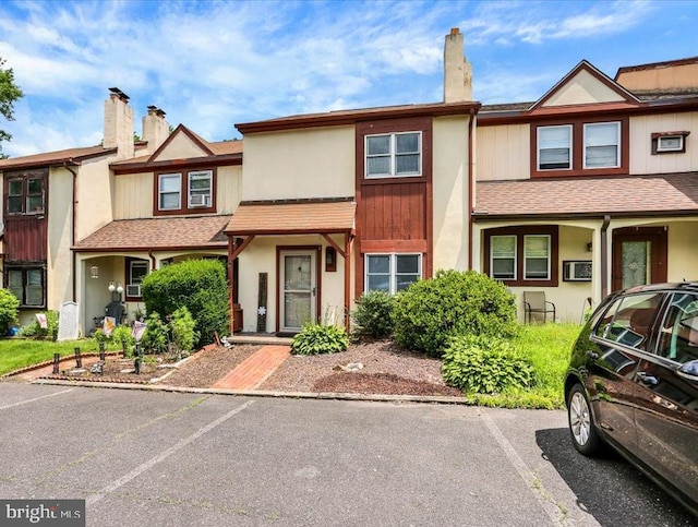 306 Walnut Rdg, Pottstown, PA 19464 - townhome / multi-family property featuring roof with shingles, a chimney, stucco siding, and uncovered parking
