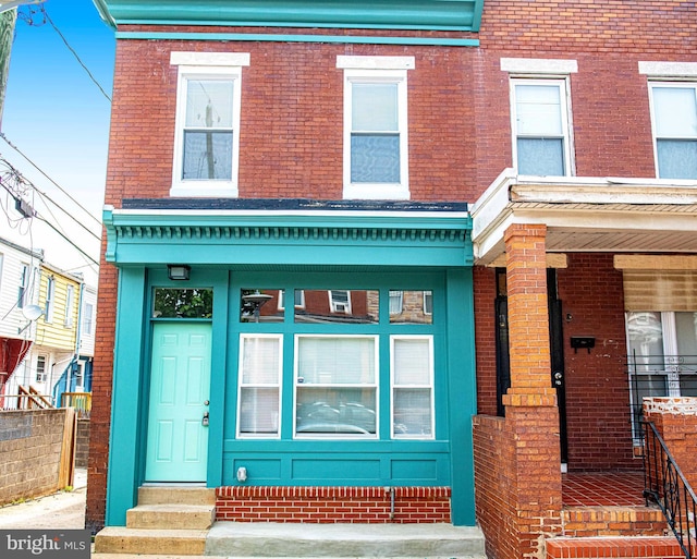 535 N Decker Ave, Baltimore, MD 21205 - view of front of house featuring entry steps, brick siding, and covered porch