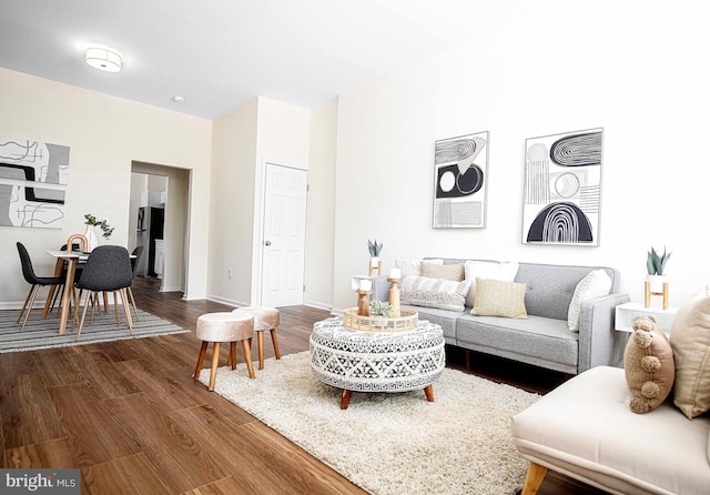 535 N Decker Ave, Baltimore, MD 21205 - living room featuring dark wood-style flooring and baseboards