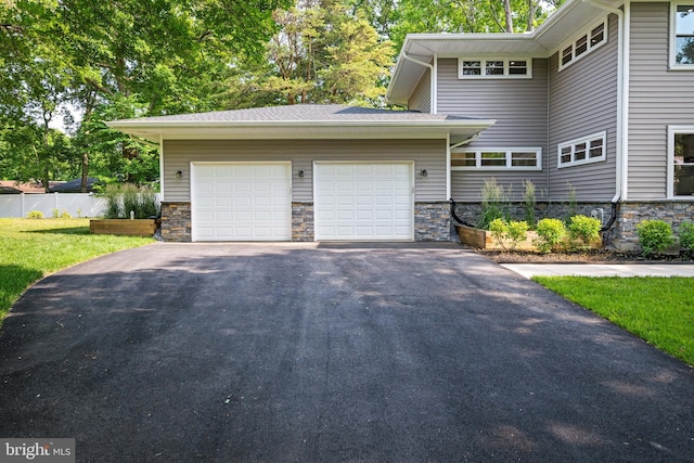 1227 Cross Rd, Annapolis, MD 21403 - view of side of property with asphalt driveway, a garage, and stone siding
