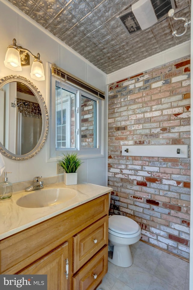 10828 Moore Dr, Manassas, VA 20111 - bathroom with vanity, an ornate ceiling, brick wall, ornamental molding, and tile patterned floors
