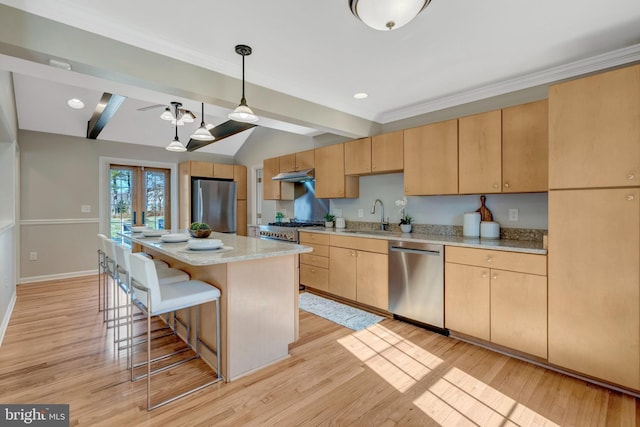10828 Moore Dr, Manassas, VA 20111 - kitchen featuring appliances with stainless steel finishes, under cabinet range hood, light brown cabinets, a breakfast bar, and light wood-type flooring
