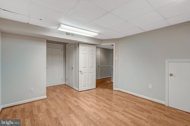 10828 Moore Dr, Manassas, VA 20111 - finished basement featuring light wood-style flooring and a paneled ceiling