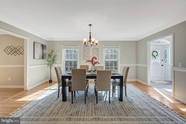 10828 Moore Dr, Manassas, VA 20111 - dining room with wood finished floors, a chandelier, plenty of natural light, and crown molding