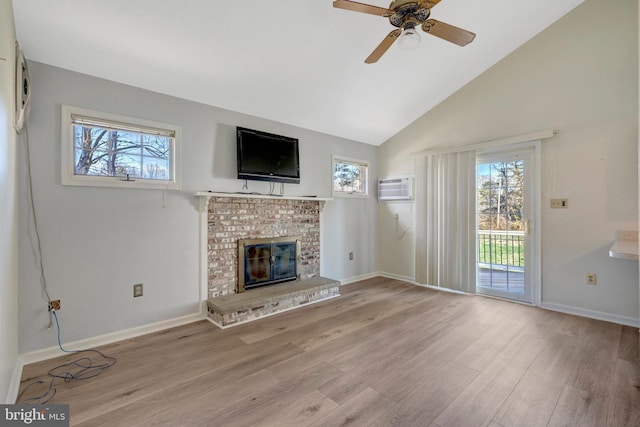 10828 Moore Dr, Manassas, VA 20111 - unfurnished living room with healthy amount of natural light, an AC wall unit, wood finished floors, ceiling fan, and high vaulted ceiling
