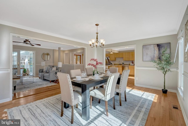 10828 Moore Dr, Manassas, VA 20111 - dining area featuring light wood-style flooring, a chandelier, ornamental molding, and ceiling fan
