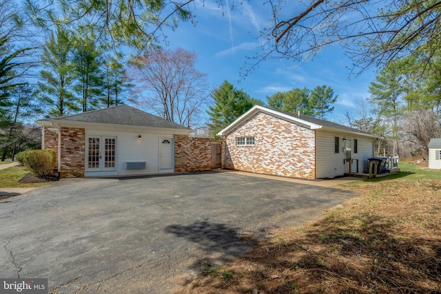 10828 Moore Dr, Manassas, VA 20111 - view of side of property with french doors and brick siding