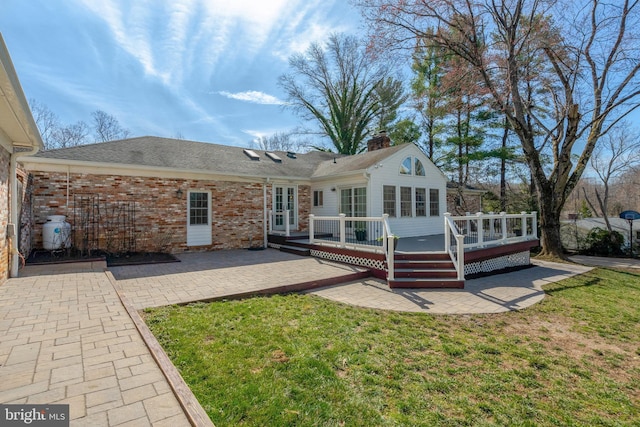 10828 Moore Dr, Manassas, VA 20111 - back of property featuring a patio area, a yard, a chimney, and a wooden deck