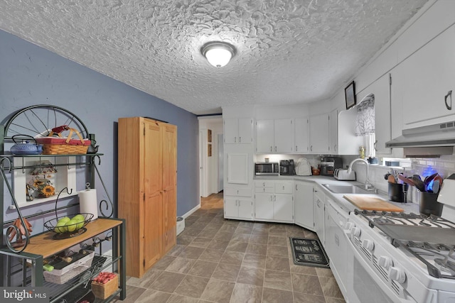 755 W Market St, Orwigsburg, PA 17961 - kitchen featuring stainless steel microwave, white range with gas cooktop, under cabinet range hood, a textured ceiling, and white cabinets