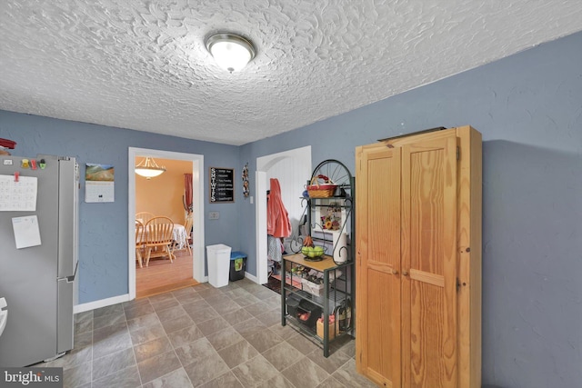 755 W Market St, Orwigsburg, PA 17961 - bedroom with freestanding refrigerator, a textured ceiling, and arched walkways