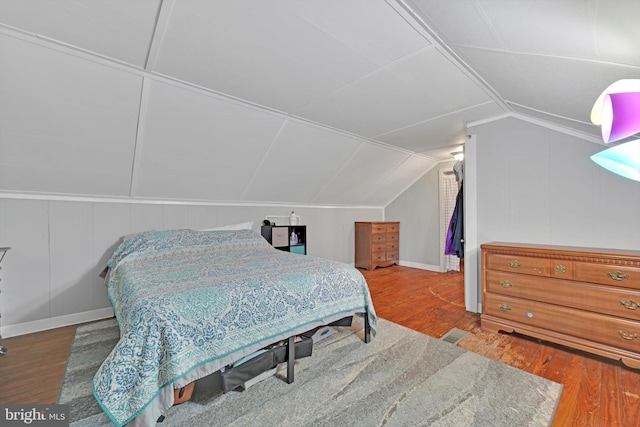 755 W Market St, Orwigsburg, PA 17961 - bedroom featuring wood finished floors, a decorative wall, and vaulted ceiling