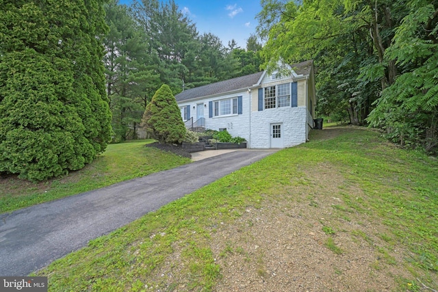 755 W Market St, Orwigsburg, PA 17961 - ranch-style house with stone siding, asphalt driveway, a front lawn, and roof with shingles