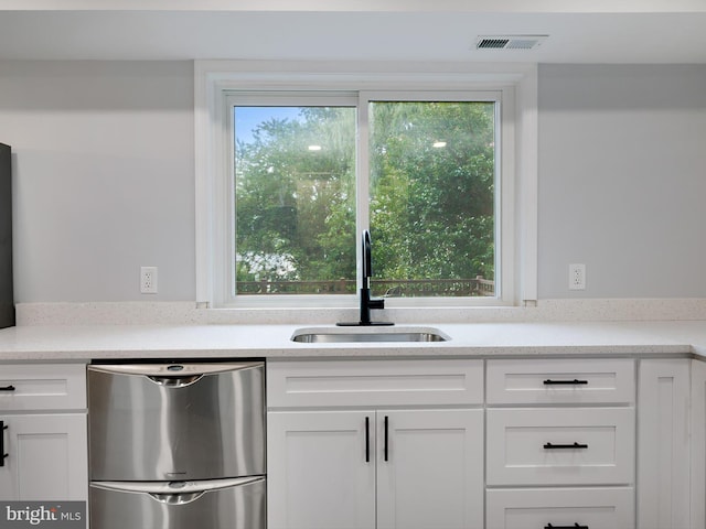 7811 Harbor Rd, Pasadena, MD 21122 - kitchen featuring dishwasher and white cabinets