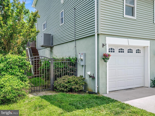 7811 Harbor Rd, Pasadena, MD 21122 - view of home's exterior featuring an attached garage, stucco siding, and stairway