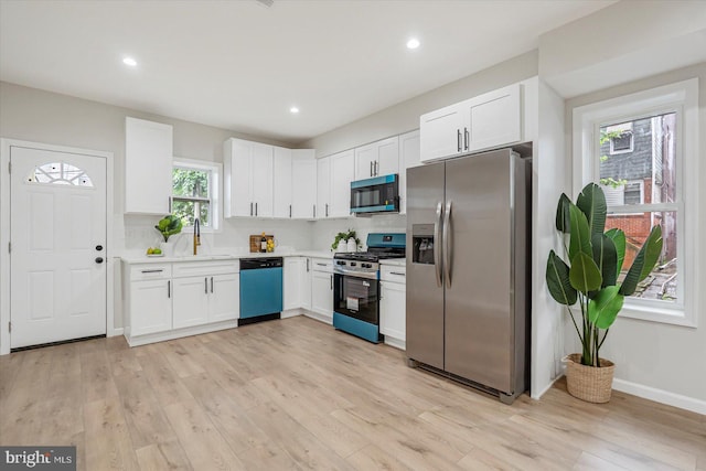 3209 Grayson St, Baltimore, MD 21216 - kitchen featuring stainless steel appliances, white cabinetry, light wood-type flooring, and recessed lighting