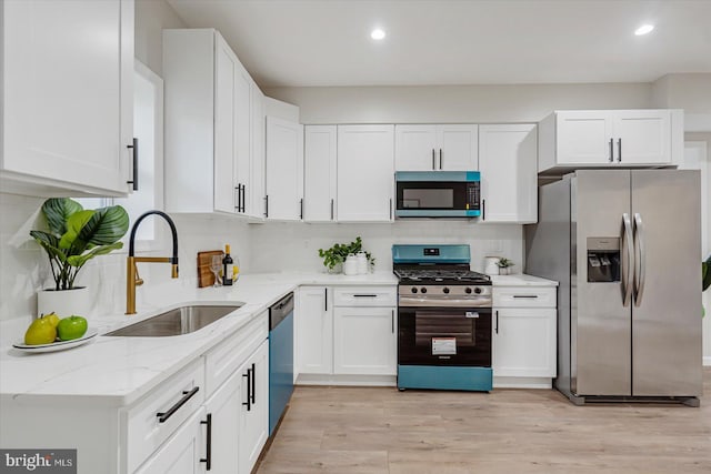 3209 Grayson St, Baltimore, MD 21216 - kitchen featuring appliances with stainless steel finishes, light stone counters, white cabinets, recessed lighting, and tasteful backsplash