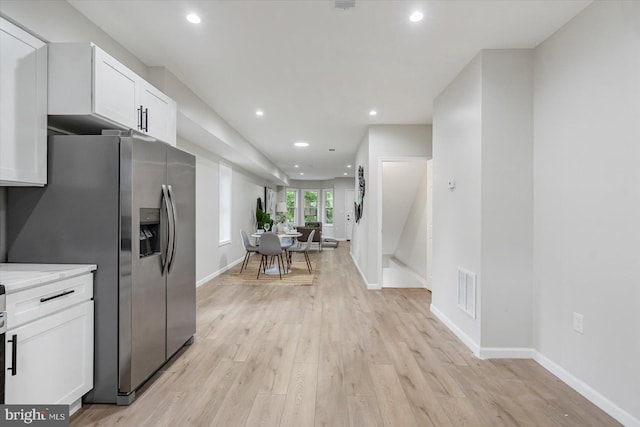 3209 Grayson St, Baltimore, MD 21216 - kitchen featuring stainless steel refrigerator with ice dispenser, white cabinets, light wood-type flooring, recessed lighting, and light countertops