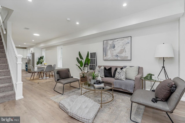 3209 Grayson St, Baltimore, MD 21216 - living room with stairway, light wood-style floors, and recessed lighting