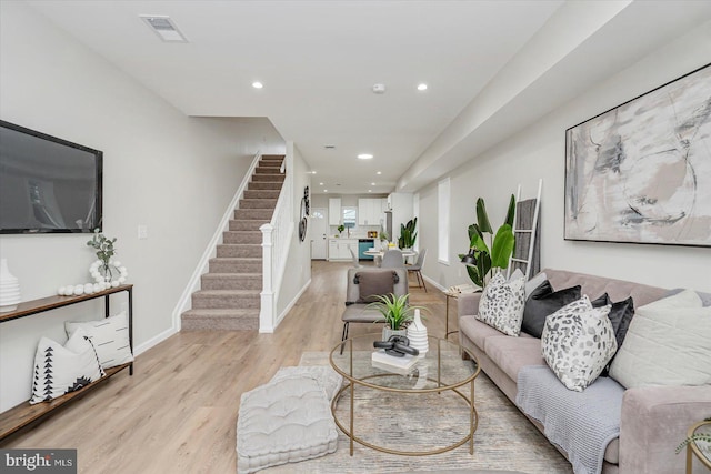 3209 Grayson St, Baltimore, MD 21216 - living area with stairway, light wood finished floors, and recessed lighting