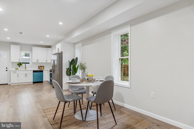3209 Grayson St, Baltimore, MD 21216 - dining space with light wood-style flooring and recessed lighting