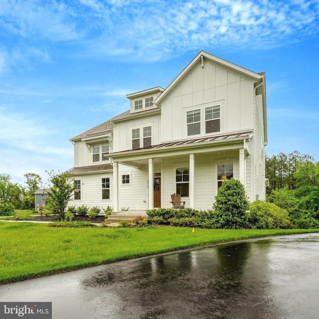40928 Arcadian Pond Ct, Aldie, VA 20105 - view of front of home featuring board and batten siding, a porch, a front lawn, a standing seam roof, and a metal roof