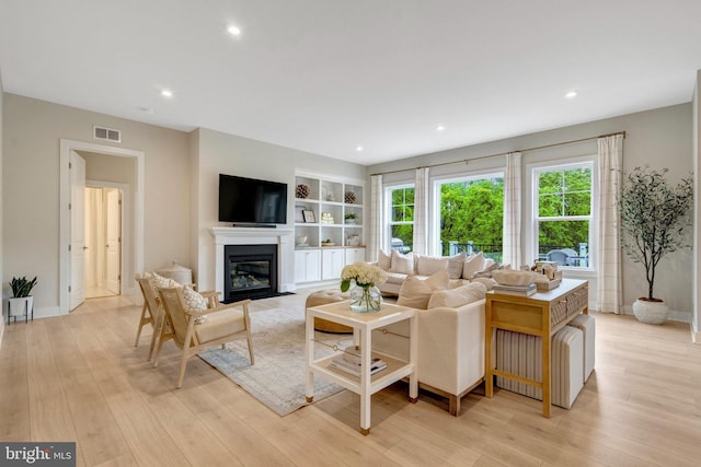 40928 Arcadian Pond Ct, Aldie, VA 20105 - living room with a fireplace with flush hearth, light wood-style flooring, recessed lighting, and built in features