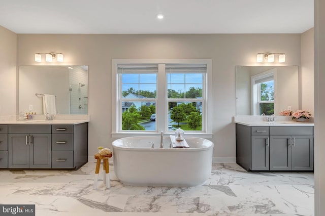 40928 Arcadian Pond Ct, Aldie, VA 20105 - bathroom with marble look tile flooring, two vanities, a soaking tub, and a shower
