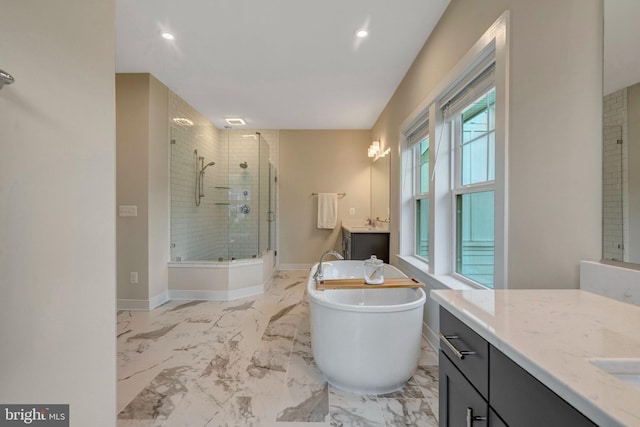 40928 Arcadian Pond Ct, Aldie, VA 20105 - full bathroom featuring two vanities, a stall shower, a soaking tub, marble finish flooring, and recessed lighting