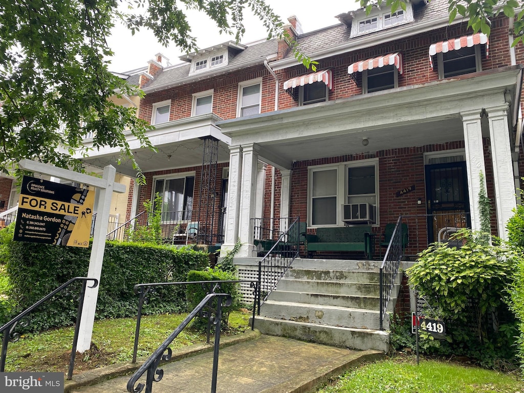 4419 New Hampshire Ave NW, Washington, DC 20011 - american foursquare style home featuring brick siding, a porch, and mansard roof