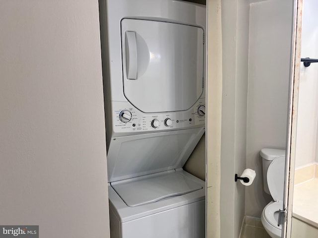 2100 Langston Blvd Unit 406, Arlington, VA 22201 - laundry area with stacked washer and clothes dryer and baseboards