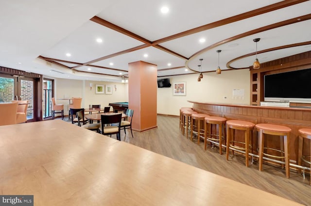 1391 Pennsylvania Ave SE Unit 247, Washington, DC 20003 - indoor dry bar featuring light wood-type flooring, recessed lighting, beam ceiling, and hanging light fixtures
