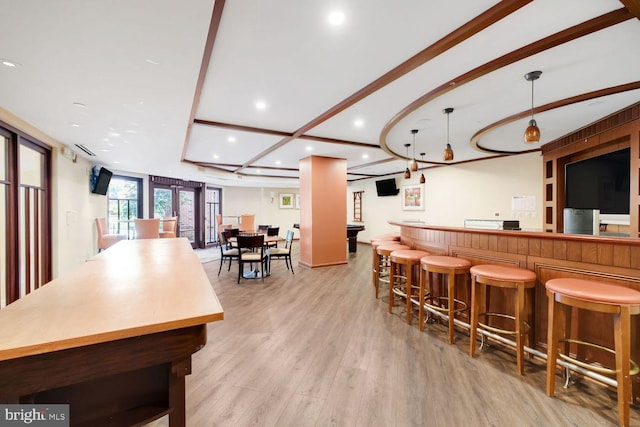 1391 Pennsylvania Ave SE Unit 247, Washington, DC 20003 - kitchen with recessed lighting, light wood-style flooring, a breakfast bar area, a spacious island, and open floor plan