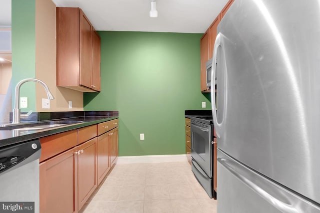 1391 Pennsylvania Ave SE Unit 247, Washington, DC 20003 - kitchen with stainless steel appliances, dark countertops, and light tile patterned floors