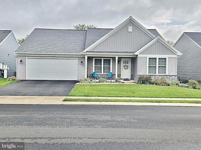 2069 Spring Wood Ln, Mechanicsburg, PA 17055 - craftsman house featuring an attached garage, board and batten siding, driveway, a front lawn, and a porch