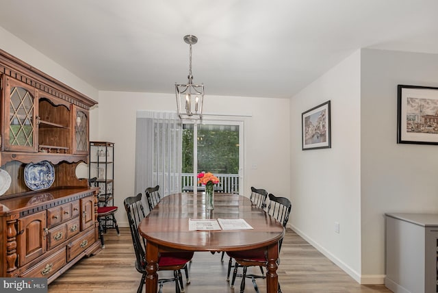 2069 Spring Wood Ln, Mechanicsburg, PA 17055 - dining area with light wood finished floors and a chandelier