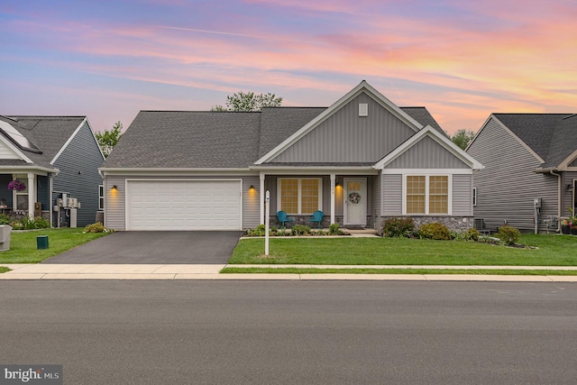 2069 Spring Wood Ln, Mechanicsburg, PA 17055 - view of front of property featuring board and batten siding, an attached garage, asphalt driveway, a front yard, and a porch
