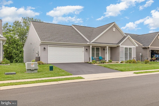 2069 Spring Wood Ln, Mechanicsburg, PA 17055 - view of front of property featuring board and batten siding, asphalt driveway, an attached garage, a front lawn, and roof with shingles