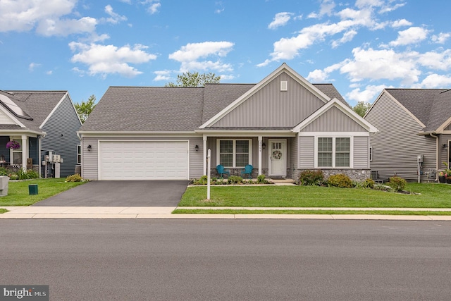 2069 Spring Wood Ln, Mechanicsburg, PA 17055 - craftsman-style house with board and batten siding, a garage, asphalt driveway, a front yard, and covered porch